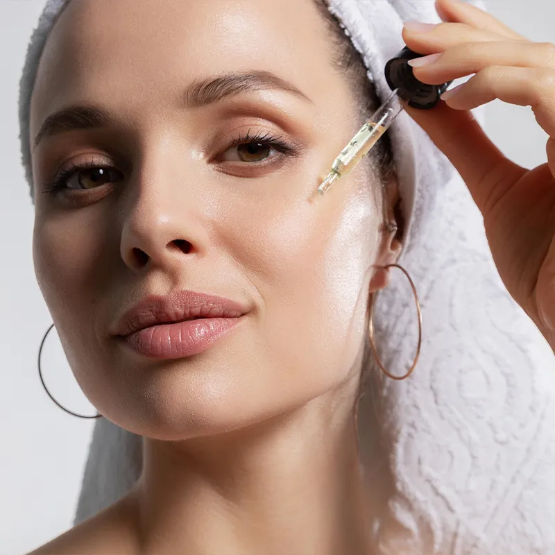 Woman using a facial serum.